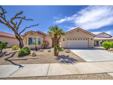 Charming single-story home with desert landscaping, mature trees, and a two-car garage at 2375 E Fiesta Dr, Casa Grande, AZ 85194