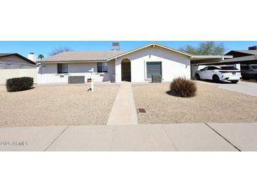 Charming single-story home featuring low-maintenance desert landscaping and a convenient covered carport at 2808 E Lupine Ave, Phoenix, AZ 85028