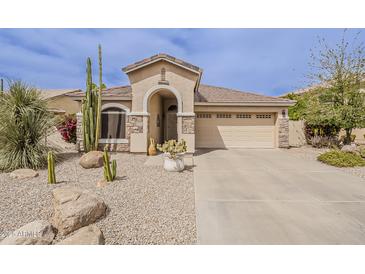Inviting single-story home with desert landscaping, neutral color palette, and attached two-car garage at 29322 N Red Finch Dr, San Tan Valley, AZ 85143