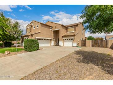 Spacious two-story home with a three-car garage and extended driveway on a sunny day at 38397 N Nuevo Laredo Ln, San Tan Valley, AZ 85140