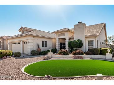 Charming home exterior featuring desert landscaping and a perfectly manicured circular grass area at 5140 S Tanglewood Dr, Chandler, AZ 85248