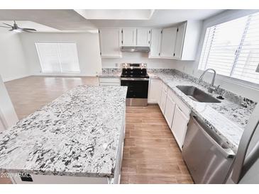 Open concept kitchen features stainless steel appliances and granite countertops at 2416 W Stottler Dr, Chandler, AZ 85224
