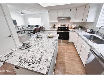 Stylish kitchen features granite countertops, stainless steel appliances, and a central island at 2416 W Stottler Dr, Chandler, AZ 85224
