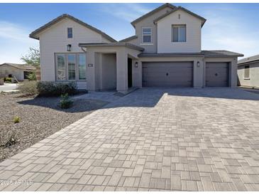 Charming two-story home featuring a three-car garage and a welcoming entrance at 11663 W Luxton Ln, Avondale, AZ 85323
