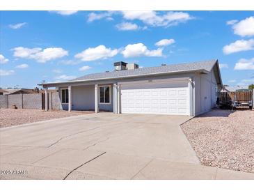 Charming single-level home featuring a two-car garage and low-maintenance desert landscaping at 15814 N 62Nd Cir, Glendale, AZ 85306