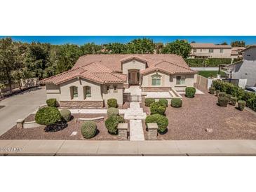 Beautiful home featuring desert landscaping, a tiled roof, stone accents and a grand entrance at 1834 E Scorpio Pl, Chandler, AZ 85249