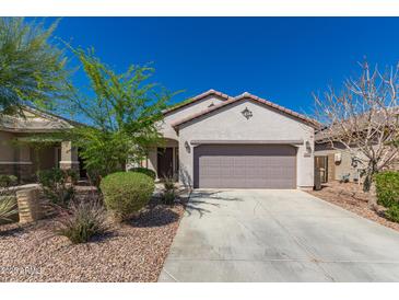 Charming single-story home featuring a desert-landscaped front yard and attached two-car garage at 19726 W Woodlands Ave, Buckeye, AZ 85326