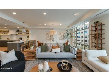 Open concept living area with modern furnishings and natural light at 2211 E Camelback Rd # 402, Phoenix, AZ 85016
