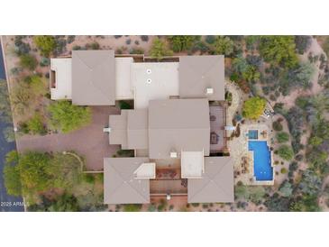 Breathtaking aerial view of luxury home featuring a sparkling pool and meticulously landscaped backyard at 36389 N 105Th Pl, Scottsdale, AZ 85262