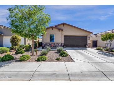 Charming single-story home featuring low maintenance desert landscaping, stone accents, and a spacious two-car garage at 4027 W Copperleaf Dr, San Tan Valley, AZ 85144