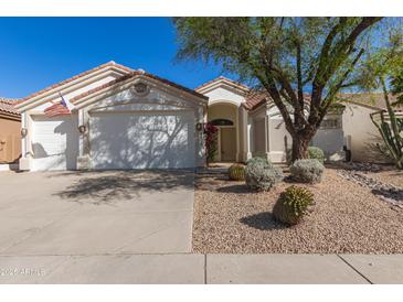 Charming single-story home featuring a well-maintained front yard with desert landscaping and a two-car garage at 4815 E Fernwood Ct, Cave Creek, AZ 85331