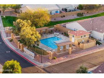 Beautiful community pool with seating and shaded areas for relaxation at 7010 W Downspell Dr, Peoria, AZ 85345