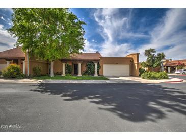 Charming single-story home featuring a well-manicured front yard and covered entryway, located on a quiet street at 7807 E Granada Rd, Scottsdale, AZ 85257