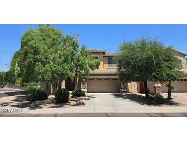 Charming two-story home with a two-car garage, well-maintained landscaping, and mature trees in a residential neighborhood at 1101 S Hazel St, Gilbert, AZ 85296