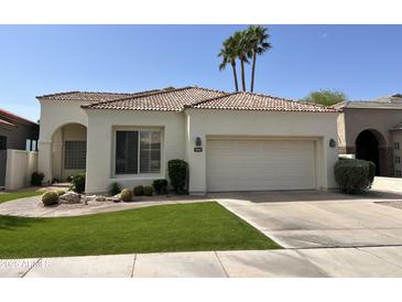 Charming single-story home with a two-car garage, desert landscaping, and a red tile roof at 11645 E Bella Vista Dr, Scottsdale, AZ 85259