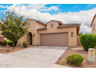 Charming single-story home with a neutral stucco exterior, a two-car garage, and low-maintenance landscaping at 1437 E Flamingo Way, Gilbert, AZ 85297