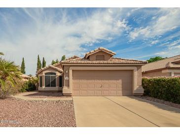 Charming single-story home featuring a two-car garage, tile roof, and well-maintained landscaping at 1439 S Dodge St, Gilbert, AZ 85233