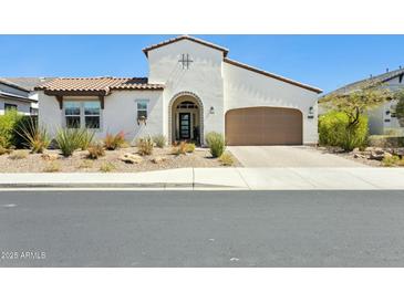 Beautiful single-Gathering home with a well-maintained xeriscaped front yard and an attached two-car garage at 22743 N 97Th Dr, Peoria, AZ 85383