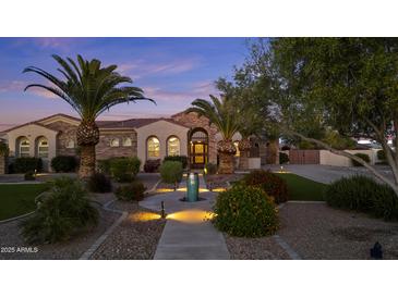 Charming single-story home with a tile roof, arched windows, lush landscaping, and inviting curb appeal at 24695 S 195Th Way, Queen Creek, AZ 85142