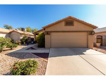 Charming single-story home with a well-maintained front yard and a two-car garage at 3017 W Matthew Dr, Phoenix, AZ 85027