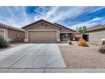 Charming single-story home with desert landscaping, a spacious driveway, and a two-car garage at 30458 N Sunray Dr, San Tan Valley, AZ 85143