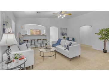 Open floor plan with a view from the living area to the kitchen bar and dining area at 4213 E Shapinsay Dr, San Tan Valley, AZ 85140