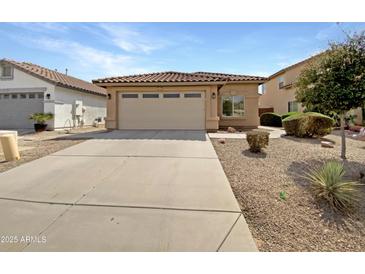 Single-Gathering home with a two-car garage and desert landscaping at 44271 W Oster Dr, Maricopa, AZ 85138