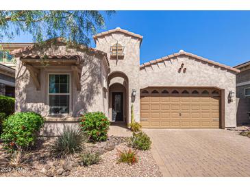 Charming home featuring stucco, tile roof, landscaped front yard, and a two-car garage at 4516 E Walter Way, Phoenix, AZ 85050