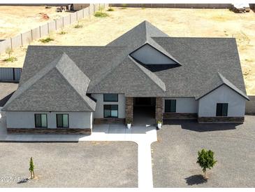 Expansive single-story home boasts gravel landscaping and gray shingles at 34949 N Donald Way, San Tan Valley, AZ 85140