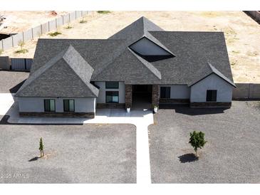 Expansive single-story home featuring a modern design, complemented by a durable roof and low-maintenance gravel landscaping at 34949 N Donald Way, San Tan Valley, AZ 85140