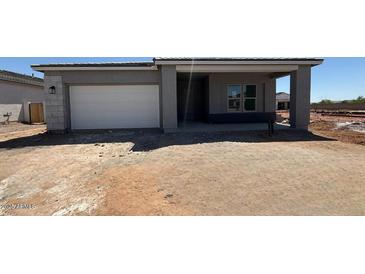 New construction single-Gathering home featuring a two-car garage and covered entry in a developing community at 11429 E Utah Ave, Mesa, AZ 85212