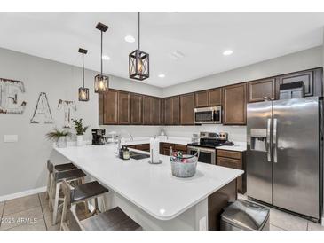 Modern kitchen featuring stainless steel appliances, quartz countertops, and ample cabinetry at 21090 E Domingo Rd, Queen Creek, AZ 85142