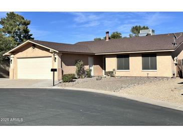 Charming single-story home with a two-car garage and low-maintenance desert landscaping in front at 10223 N 40Th Ave, Phoenix, AZ 85051