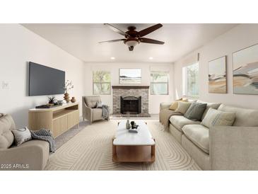 Cozy living room with a brick fireplace, ceiling fan, neutral palette, and ample seating at 1920 E Belmont Dr, Tempe, AZ 85284