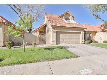 Beautiful single-Gathering home featuring manicured lawn, mature tree, and convenient two-car garage at 4670 W Linda Ln, Chandler, AZ 85226