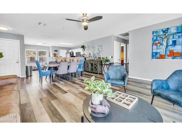 Open-concept living and dining room with modern furniture and decor, great for entertaining at 8972 E Arizona Park Pl, Scottsdale, AZ 85260