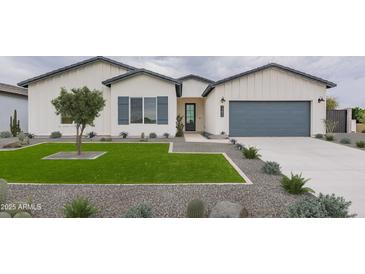Charming home with a well-manicured lawn, stylish desert landscaping, and a modern exterior at 10907 W Woodruff Rd, Casa Grande, AZ 85194