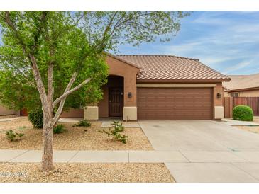 Charming single-story home featuring desert landscaping and a tile roof at 11277 W Buchanan St, Avondale, AZ 85323