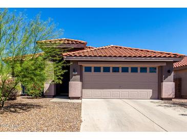 Inviting home featuring a well-maintained landscape and a classic red tile roof at 12415 N 41St Dr, Phoenix, AZ 85029