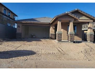 Charming single-story home with a two-car garage and covered front porch on a sunny day at 13250 W Eagle Feather Rd, Peoria, AZ 85383