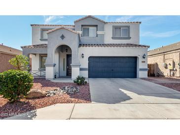 Charming two-story home with a stylish two-car garage, a landscaped yard, and a welcoming front entrance at 15856 N 76Th Ave, Peoria, AZ 85382