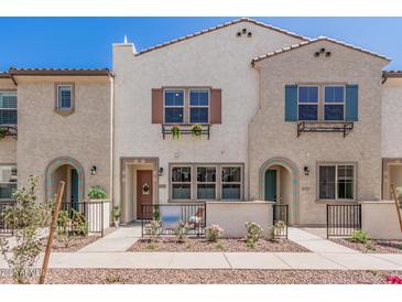 Charming two-story townhomes with stucco exteriors, colorful shutters and landscaped front yards at 2658 S Sulley Dr # 102, Gilbert, AZ 85295