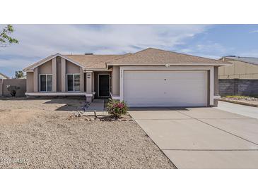 Charming single-story home featuring a two-car garage and low maintenance desert landscaping at 3327 W Mohawk Ln, Phoenix, AZ 85027