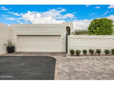 Charming single-Gathering home features a brick driveway, two-car garage, and mature landscaping at 7770 E Camelback Rd # 11, Scottsdale, AZ 85251