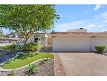 Charming home featuring a well-kept front yard with mature tree and red-tiled roof at 11465 N 56Th St, Scottsdale, AZ 85254