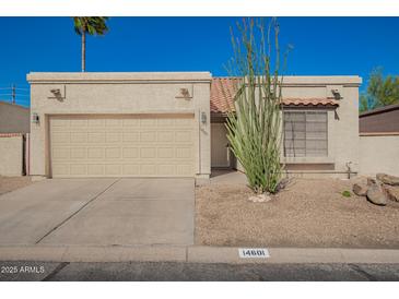 Charming single-story home featuring a low-maintenance desert landscape and attached two-car garage at 14601 N Kings Way, Fountain Hills, AZ 85268