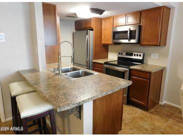 Updated kitchen with stainless steel appliances and granite countertops at 14636 N Yerba Buena Way # B, Fountain Hills, AZ 85268
