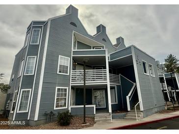 Stylish condo exterior showcasing architectural design, balconies, and stairs to the upper levels at 1505 N Center St # 220, Mesa, AZ 85201