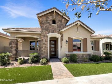 Charming single-story home featuring a stone facade, well-manicured landscaping, and a welcoming entryway at 4171 E Ronald St, Gilbert, AZ 85295