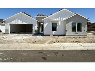 Charming new construction home featuring bright white siding and a spacious two car garage at 6460 E Omega Cir, Mesa, AZ 85215